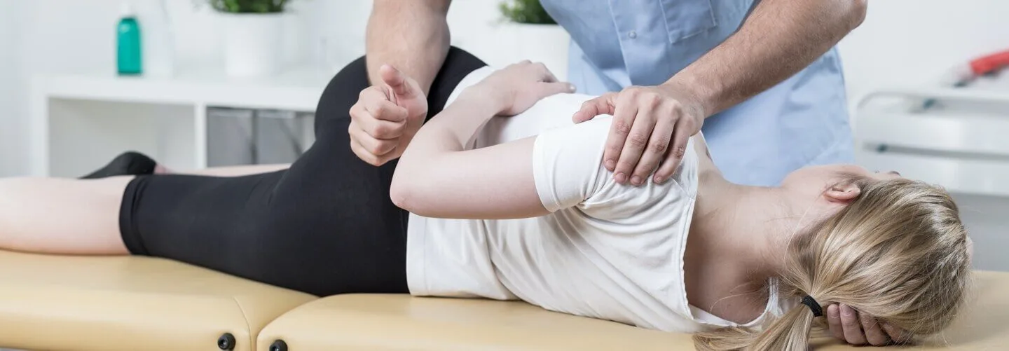 Patienten auf einer Lieg in Behandlung durch Therapeut